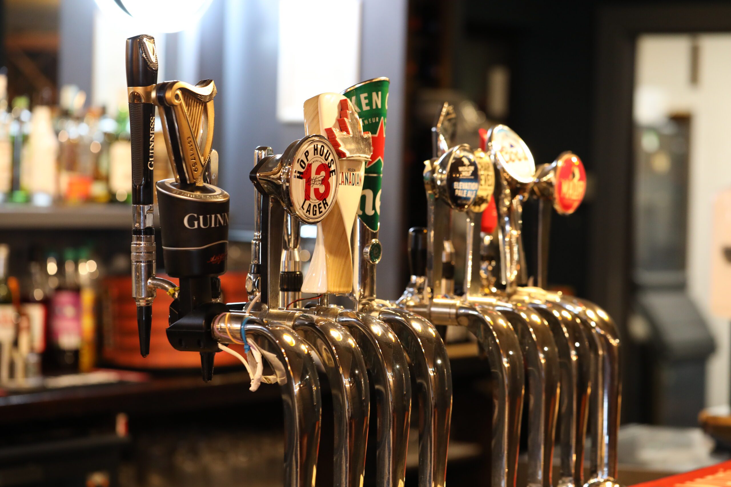 The bar inside The Mount Kennedy Inn with stools and warm light